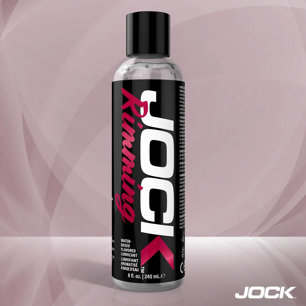 An 8oz bottle of JOCK Rimming Lubricant (Cherry) with a black label, white branding, and pink text on a light background.