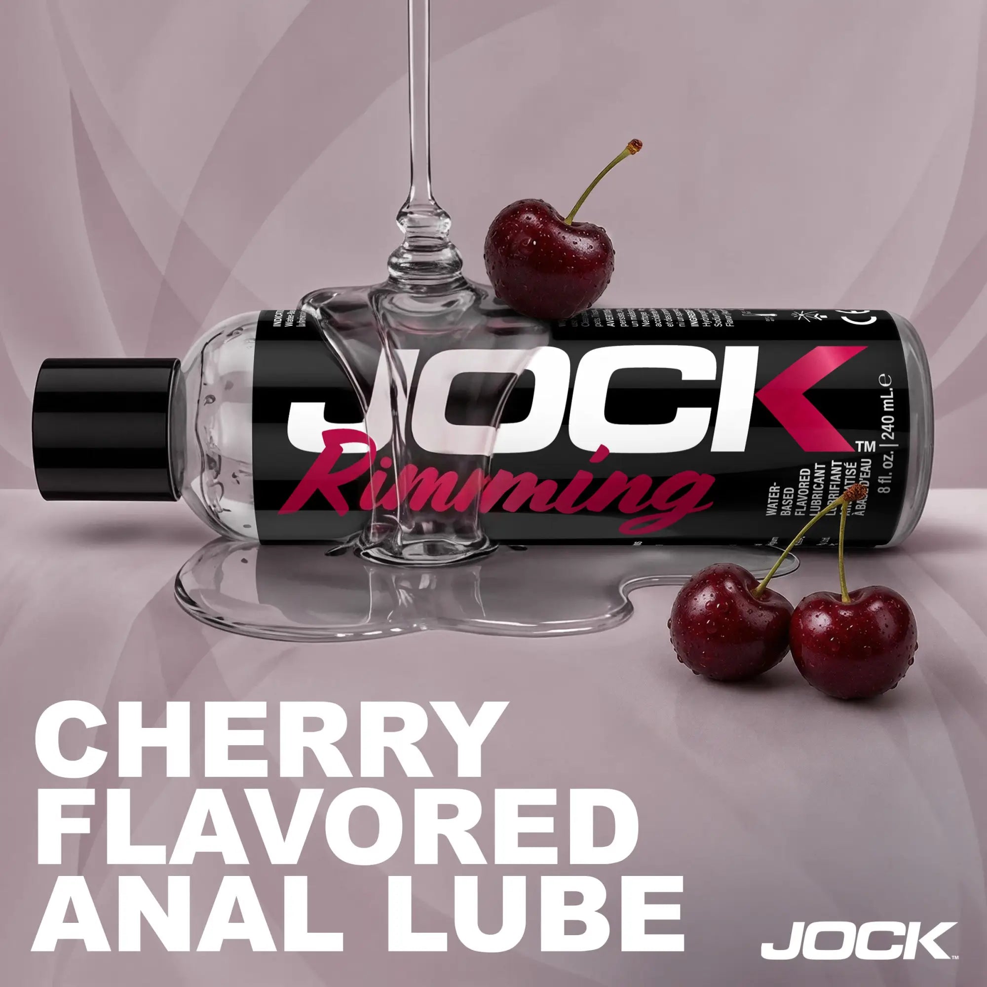 8oz bottle of Jock Rimming Cherry lubricant with clear gel dripping over it, surrounded by three fresh cherries.
