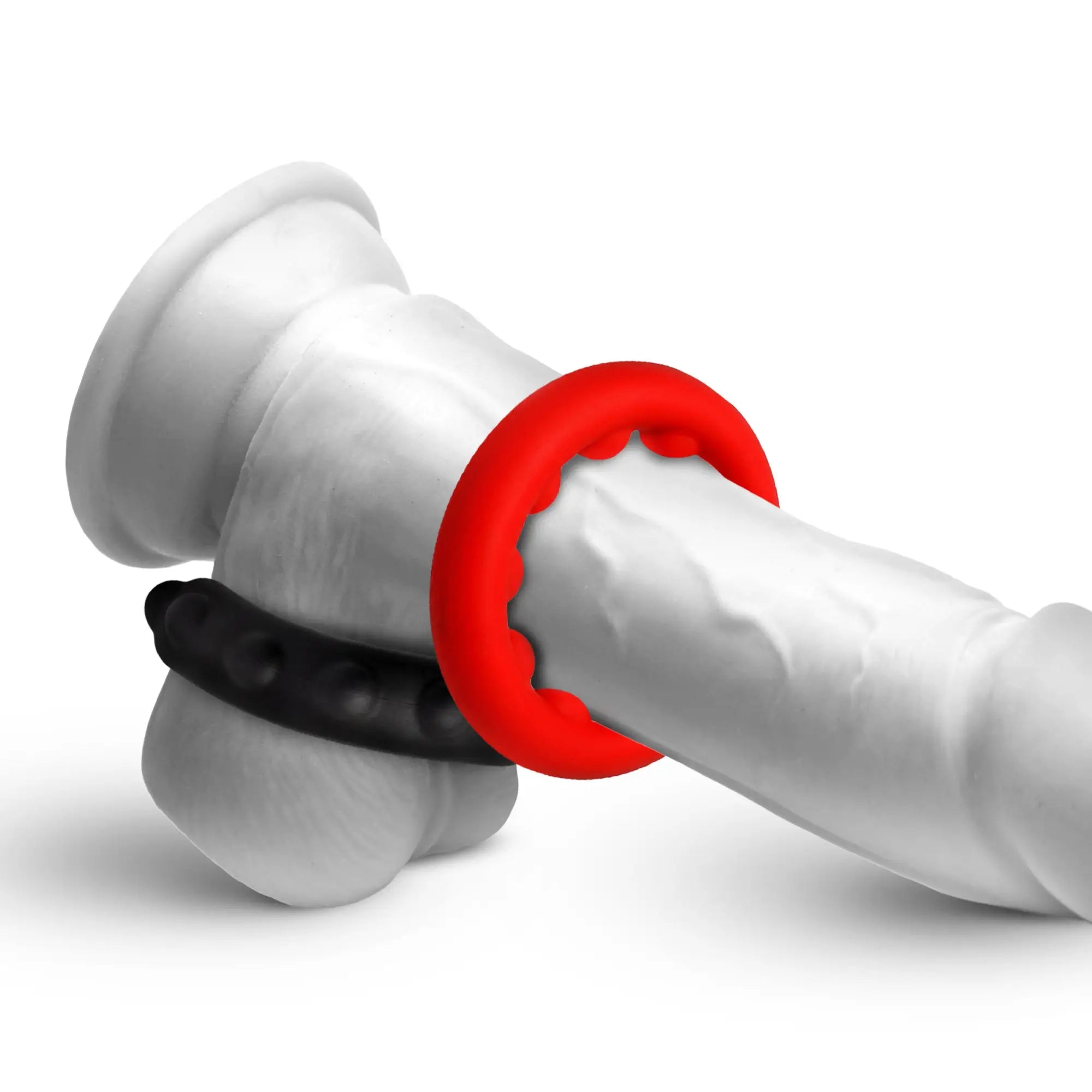 Jock Weighted Silicone C-Ring set: red and black textured silicone rings on a white phallic mannequin display.
