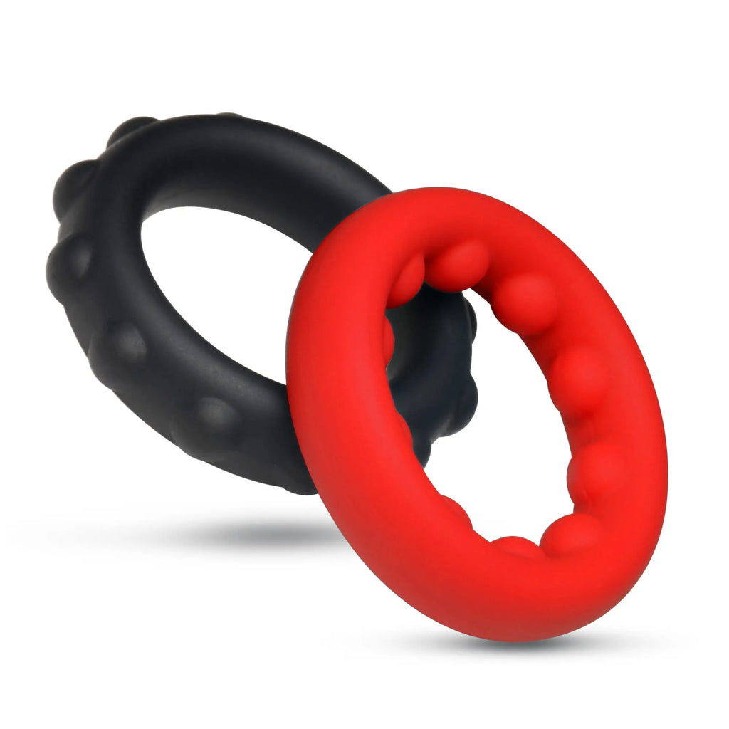 Jock Weighted Silicone C-Ring set: two textured rings in matte black and vibrant red linked against a white background.