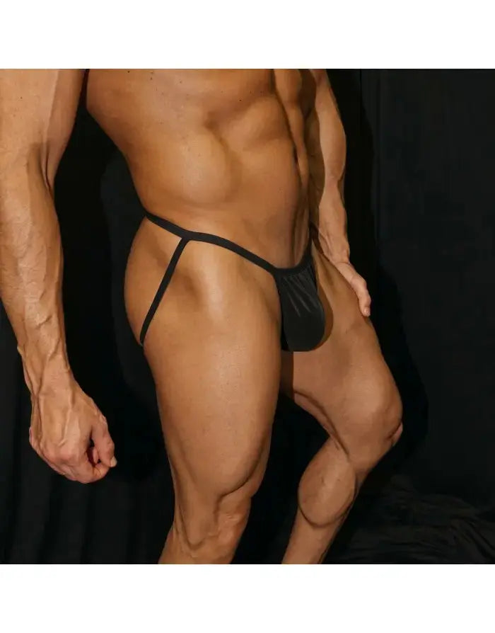 Black eco leather jockstrap underwear by Arroyman featuring a sleek design and minimal coverage shown on a model.