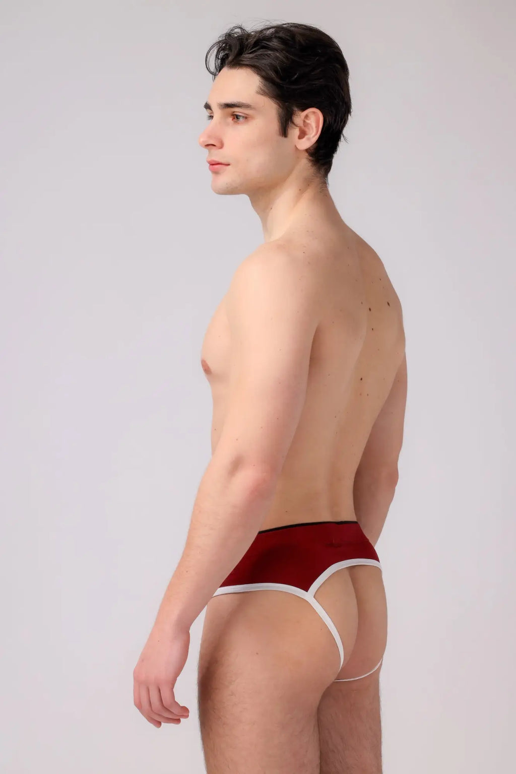 A man wearing burgundy briefs with white trim shown from the back in the AS Me Jockstrap product image