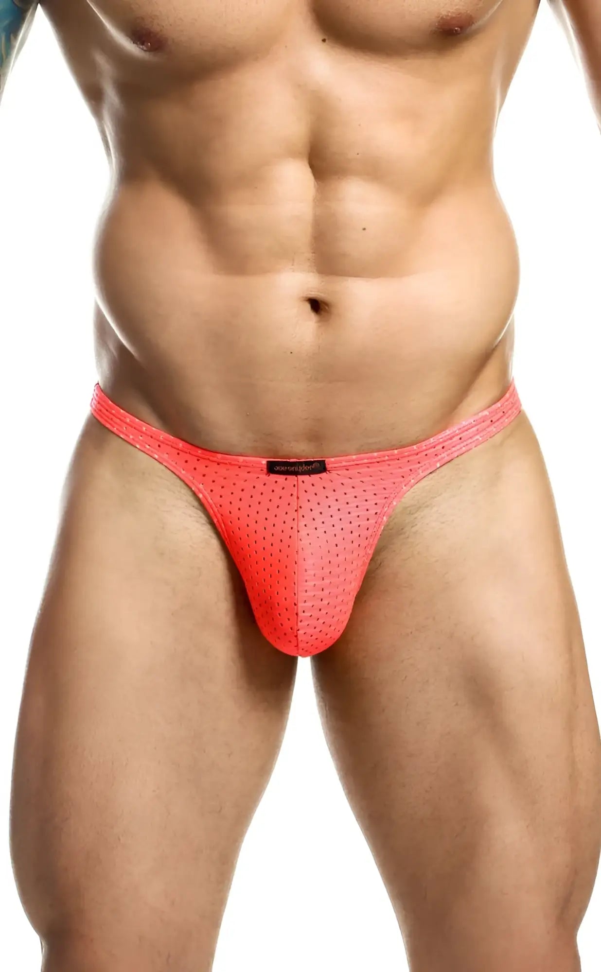 Bright coral pink joe snyder holes thong mesh briefs with subtle perforated texture and black brand tag at waistband