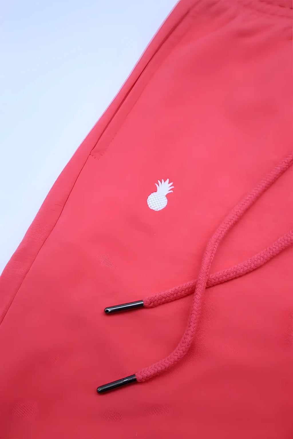 Joie limited edition cherry red cotton joggers with white pineapple logo and black aglet tipped drawstrings