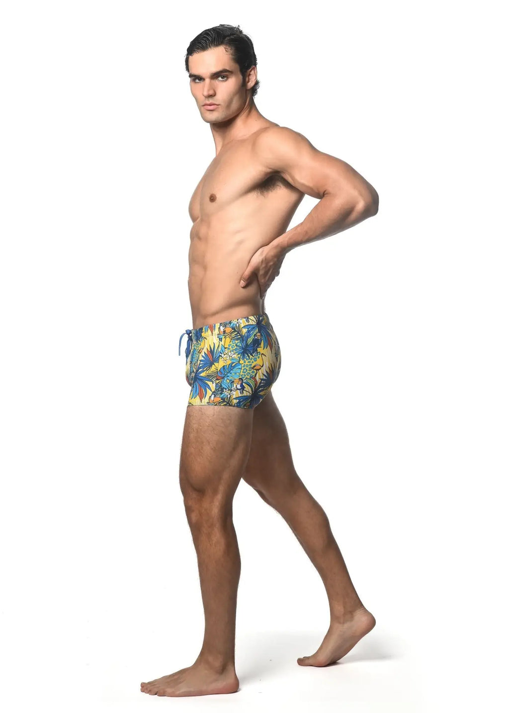 Men’s jungle printed swim trunk with vibrant tropical leaf pattern in blue yellow and green perfect for beachwear