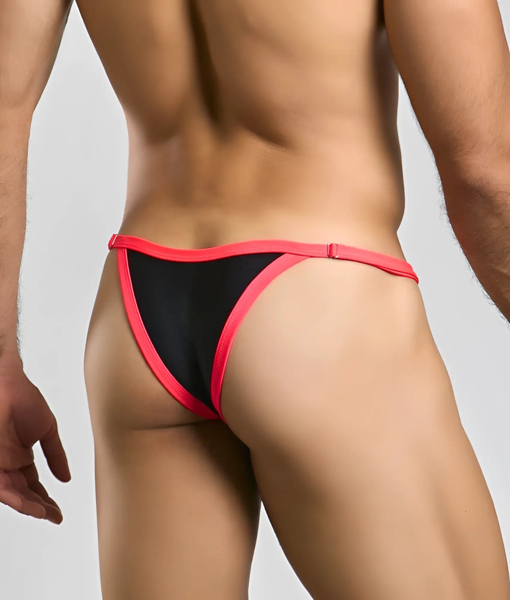Justin + Simon bikini one black and pink thong with a snug form-fitting design shown from the back side