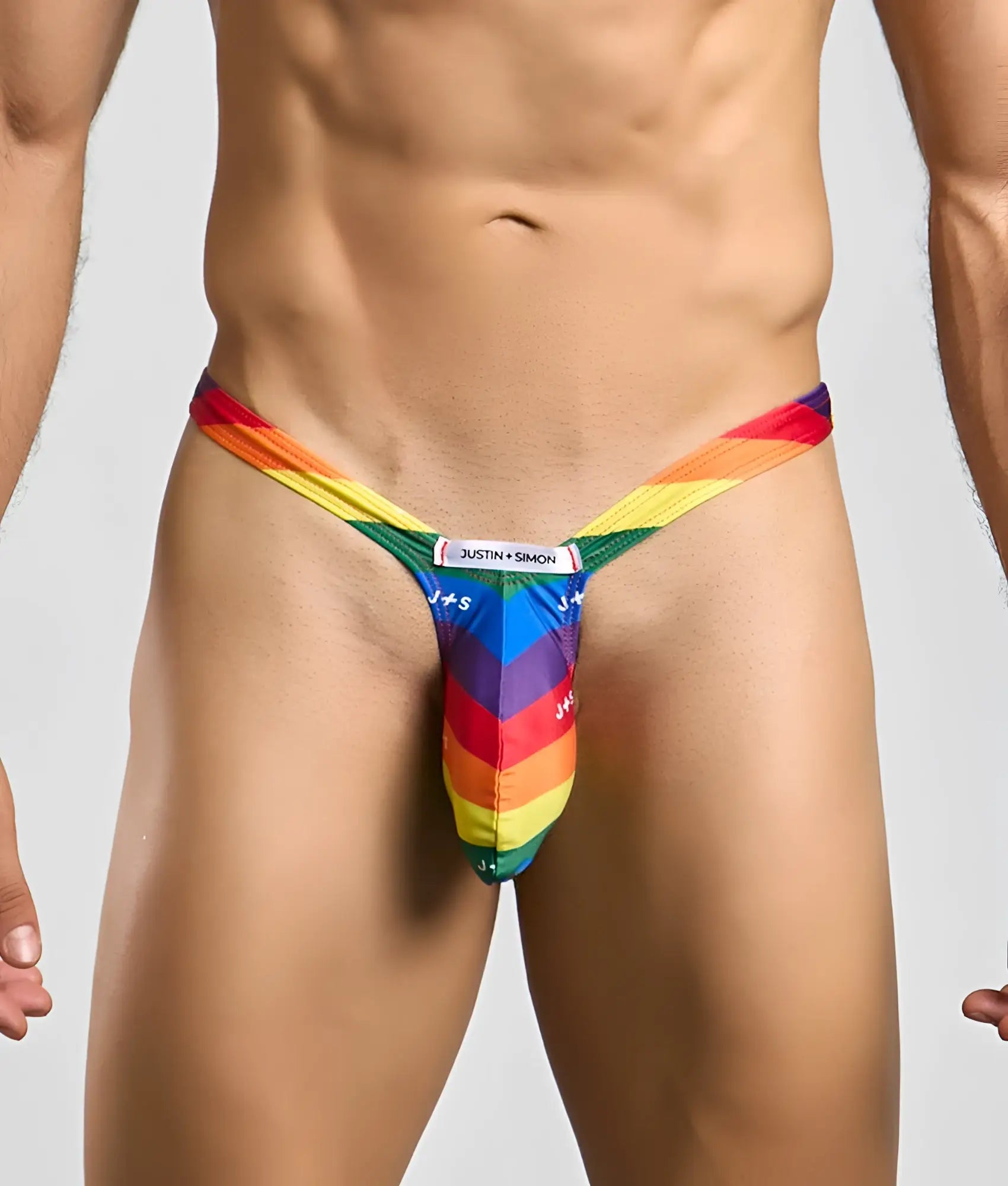 Rainbow-striped bulge thong by justin + simon showing back side with vibrant colors and minimal design