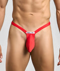 Red justin simon bulge thong with sleek form-fitting design and white brand tag at the front