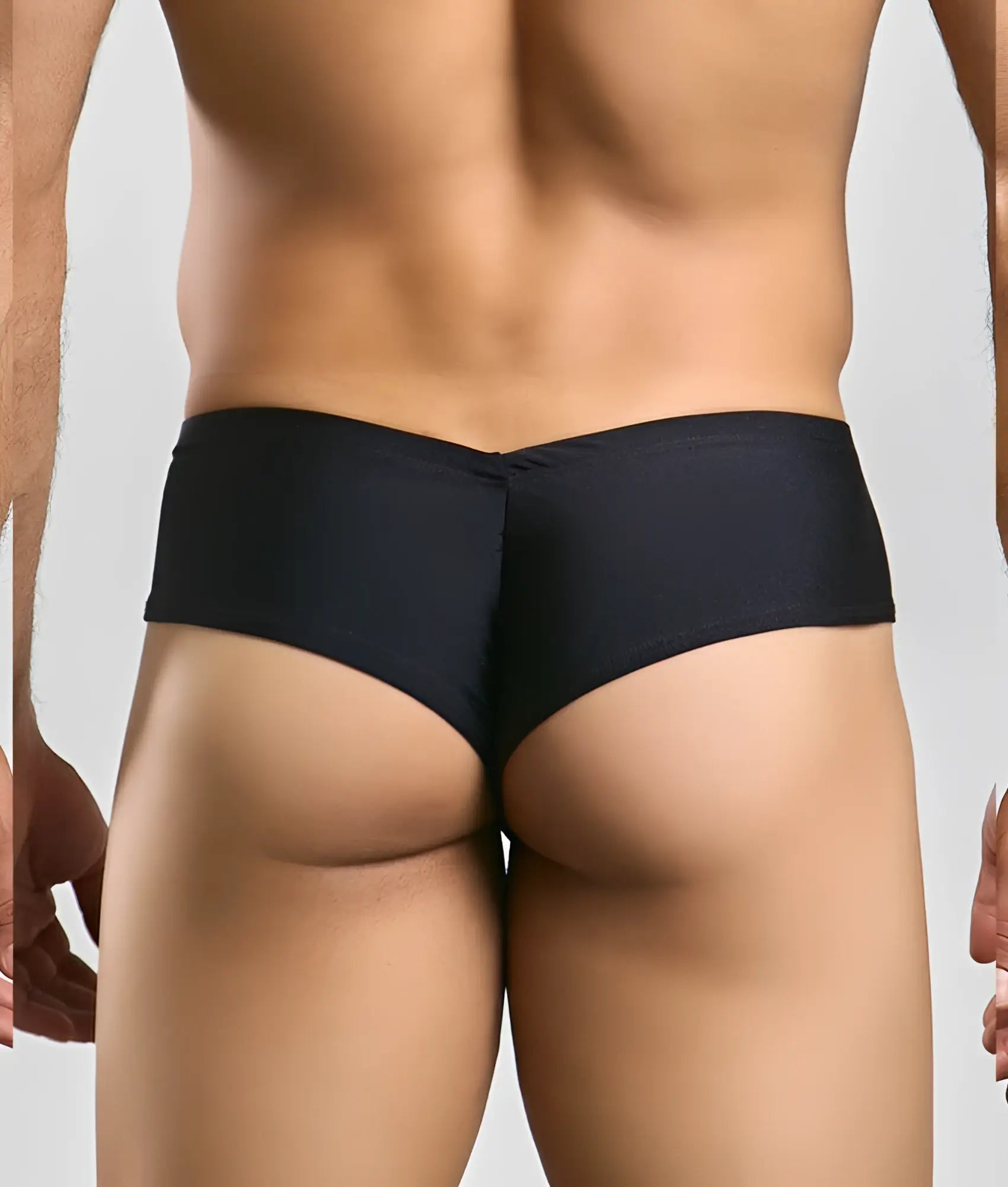 Black Justin + Simon cheek briefs with form-fitting textured fabric and centered seam shown from the back side