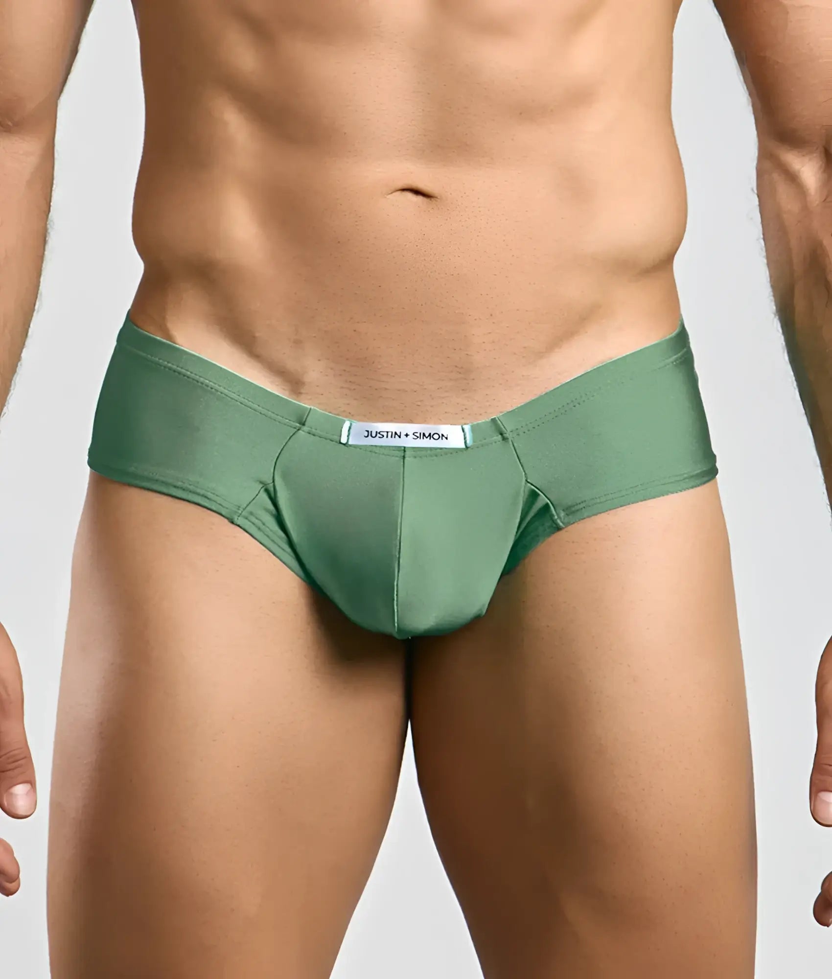 Green justin simon cheek briefs with smooth form-fitting fabric and white label at the waistband