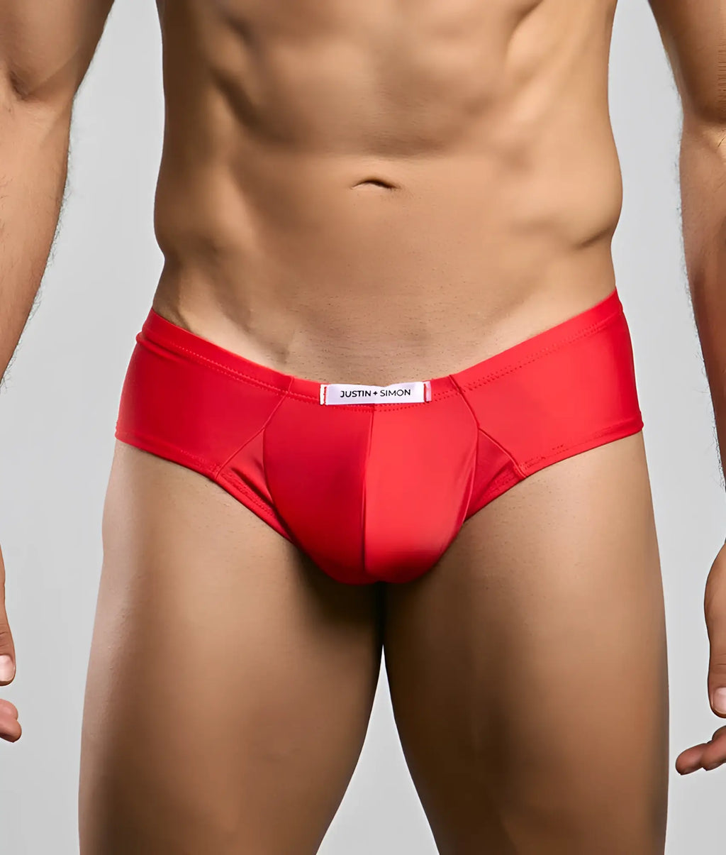 Red justin simon cheek briefs with a smooth form-fitting design and white label on the waistband