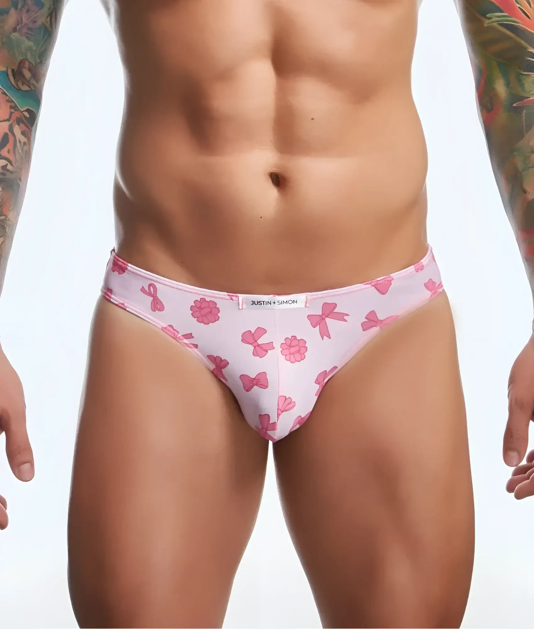 Pink patterned briefs with bow and flower designs and white brand tag from justin plus simon classic mens bikini fun prints