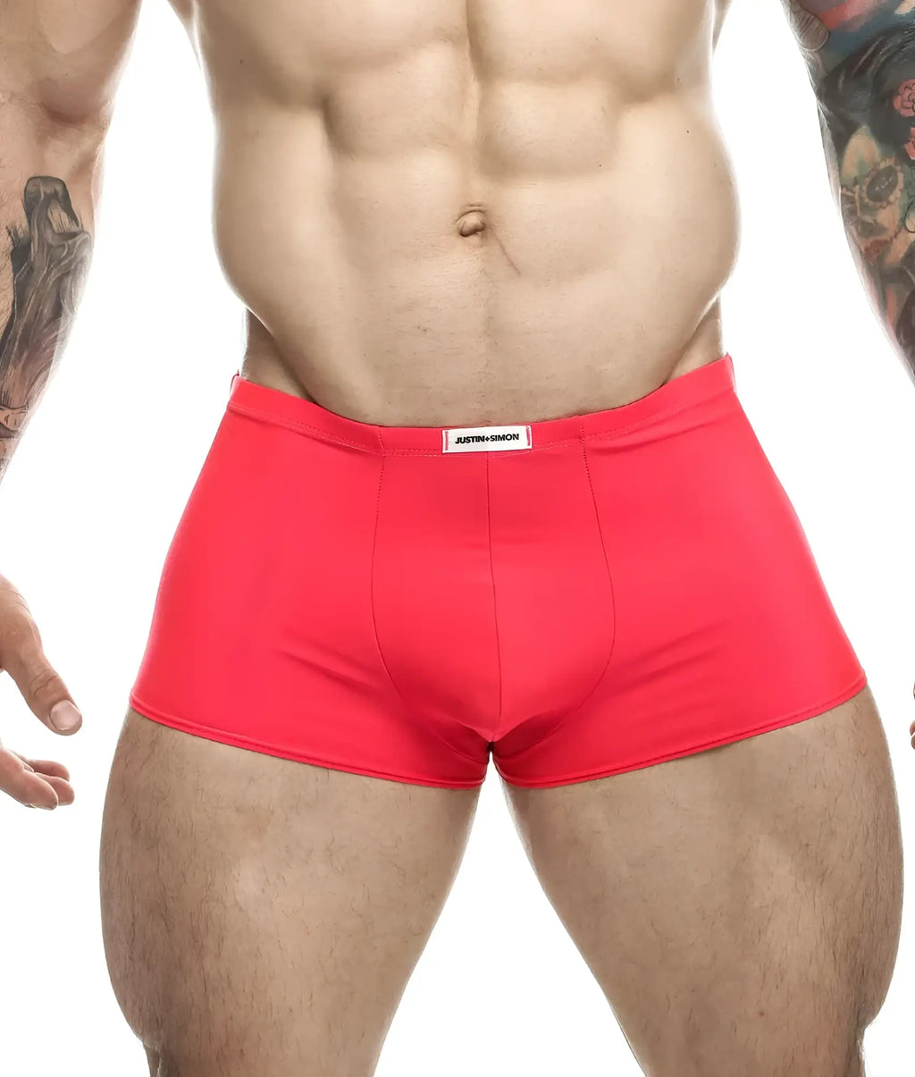 Bright red form-fitting justin simon classic boxer briefs with a white label on the waistband