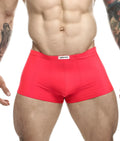 Bright red form-fitting justin simon classic boxer briefs with a white label on the waistband