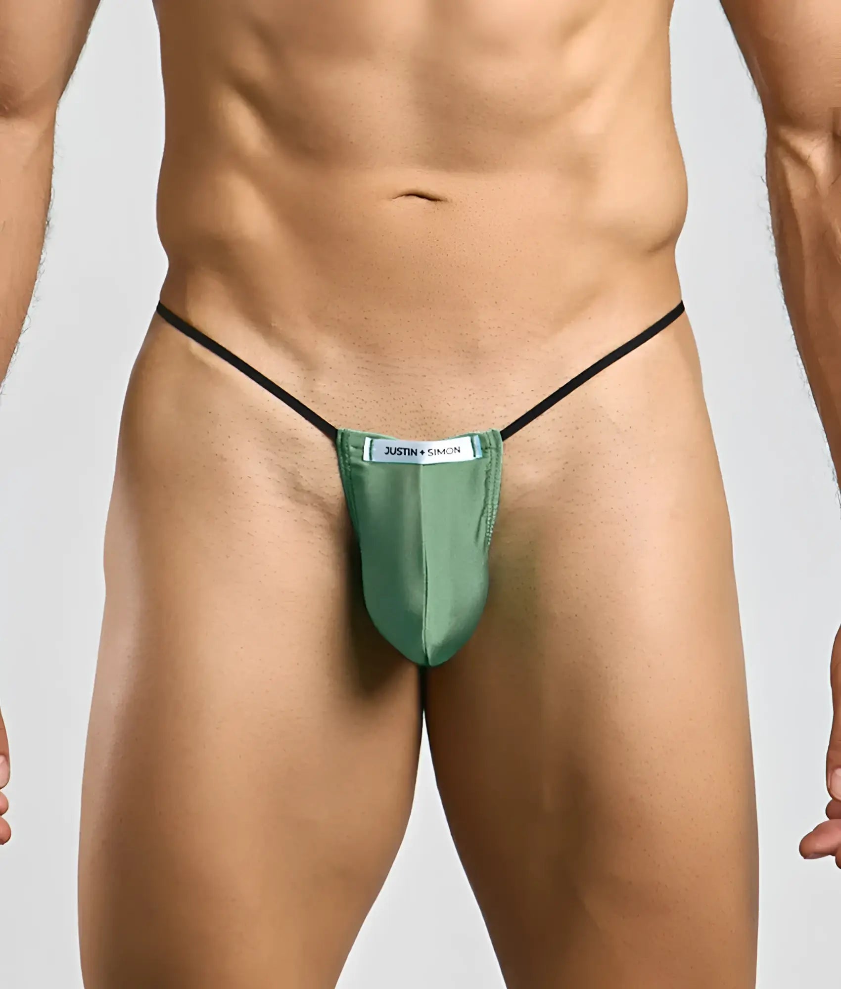 Green satin classic g-string bulge with black elastic straps and white justin simon label visible on the front side