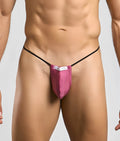 A vibrant pink Justin + Simon classic g-string bulge thong with black elastic straps and a white brand tag visible