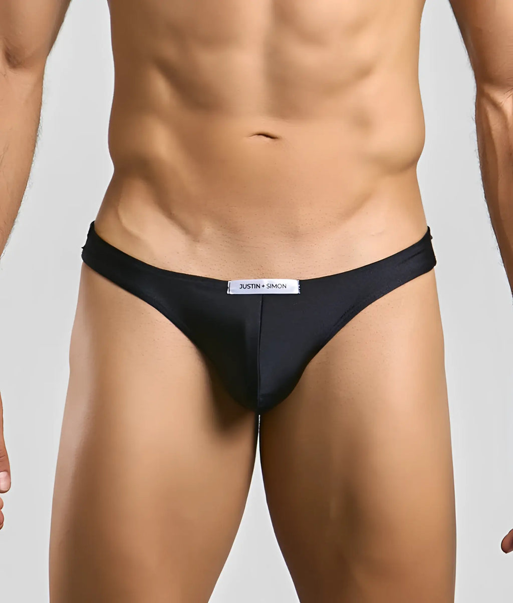 Black justin + simon classic mens bikini briefs with sleek form-fitting design and subtle brand tag at the waistband