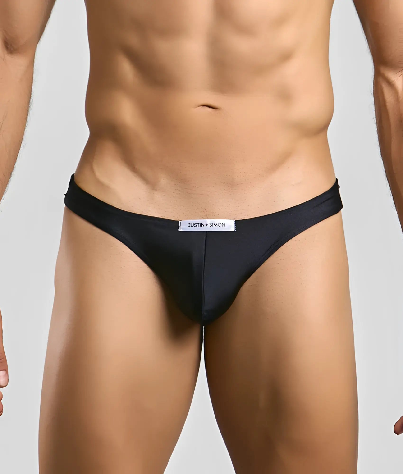 Black justin + simon classic mens bikini briefs with sleek form-fitting design and subtle brand tag at the waistband
