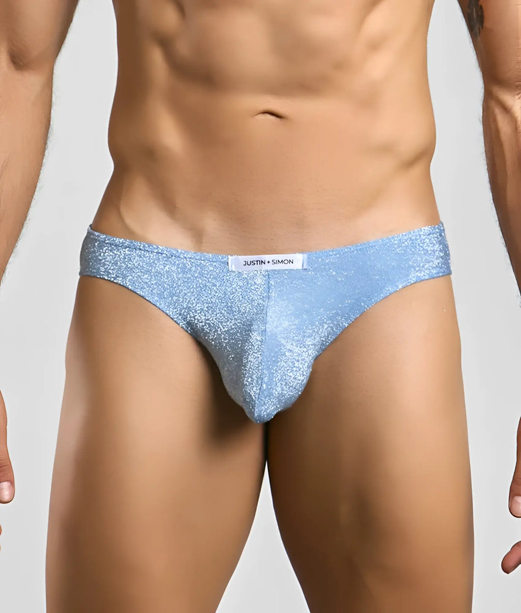 Light blue glittery men’s briefs with white justin + simon brand tag from the classic mens bikini collection