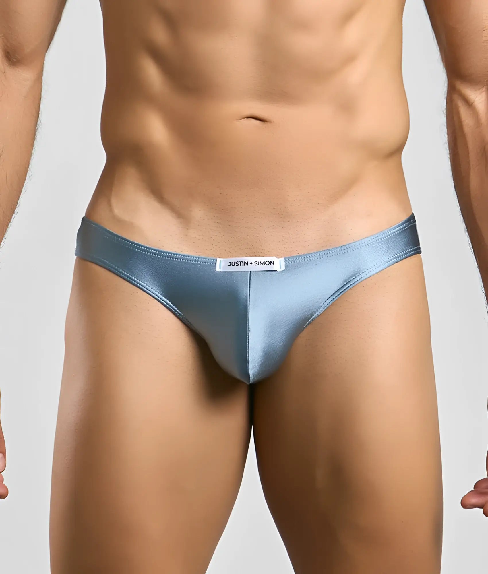Light blue satin classic mens bikini briefs with sleek form-fitting design and white brand tag at waistband by justin + simon