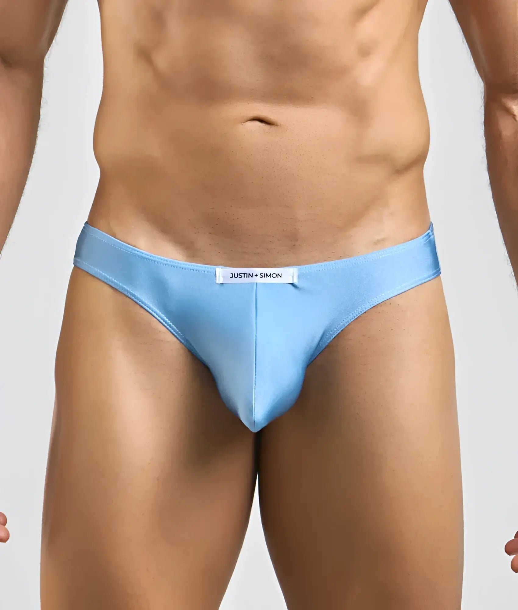 Light blue justin simon classic mens bikini briefs with sleek form fitting design and subtle brand tag at waistband