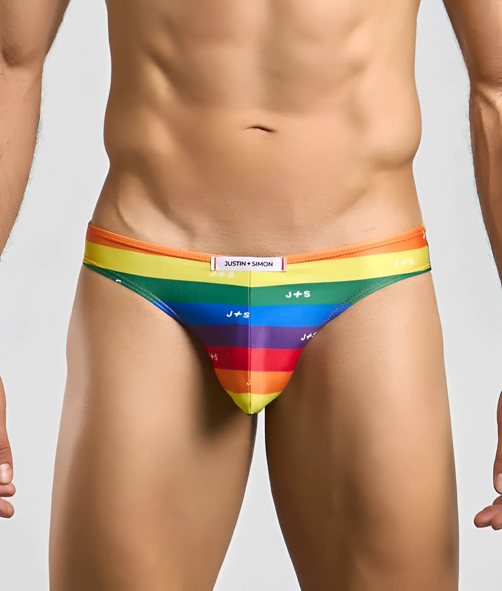 Rainbow-striped justin + simon classic mens bikini briefs with vibrant orange to purple gradient and repeating j plus s logos