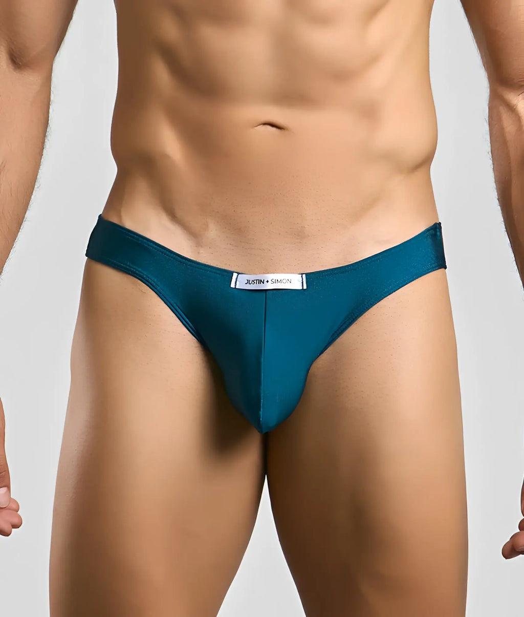 Teal classic mens bikini briefs by Justin + Simon with sleek smooth fabric and white waistband label front view