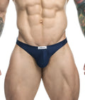 Navy blue men’s Justin + Simon classic tanga briefs with a white waistband label made of soft breathable fabric