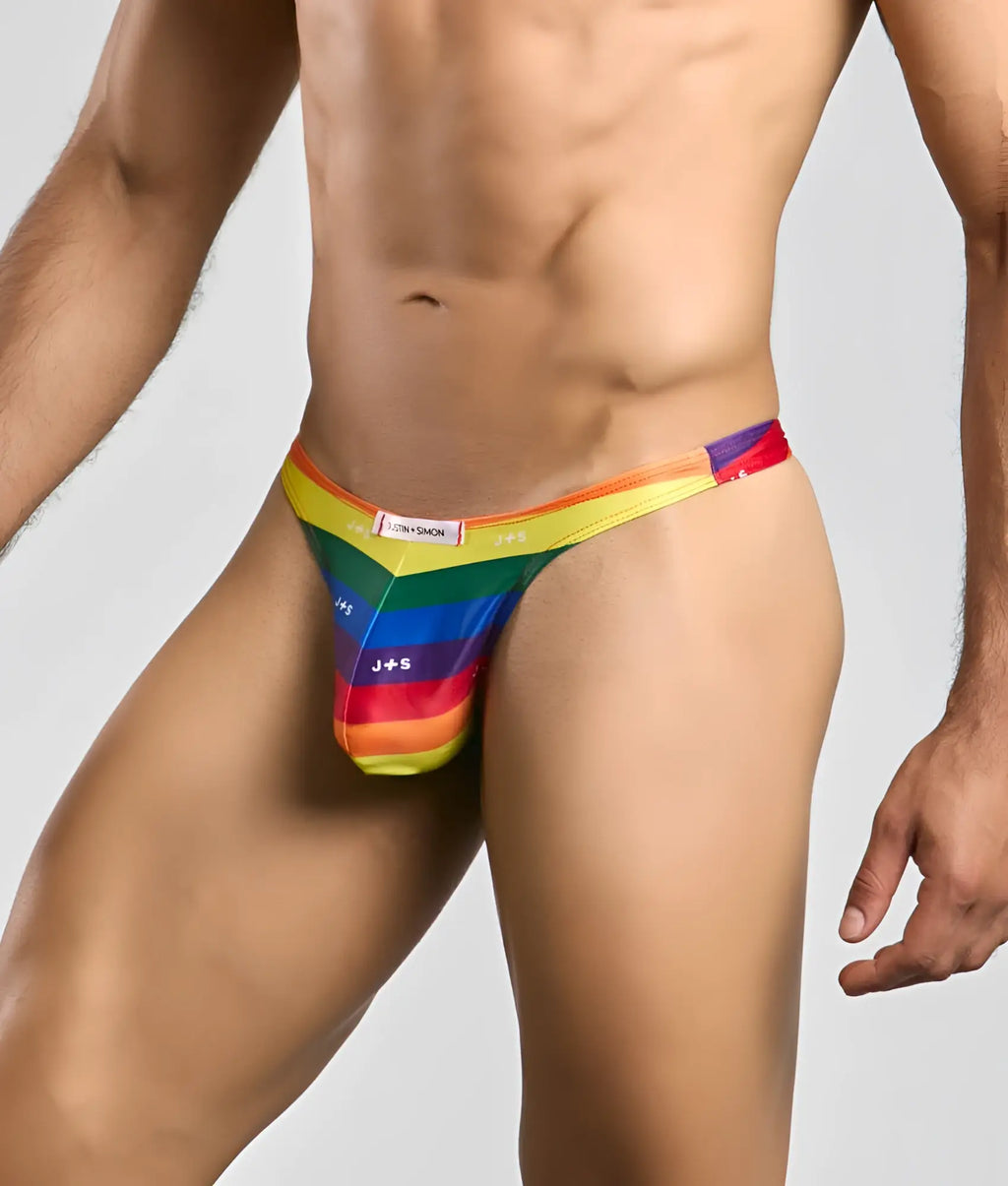 Justin + Simon Classic Tanga men’s thong with vibrant rainbow stripes and sleek form-fitting design in bold color gradient