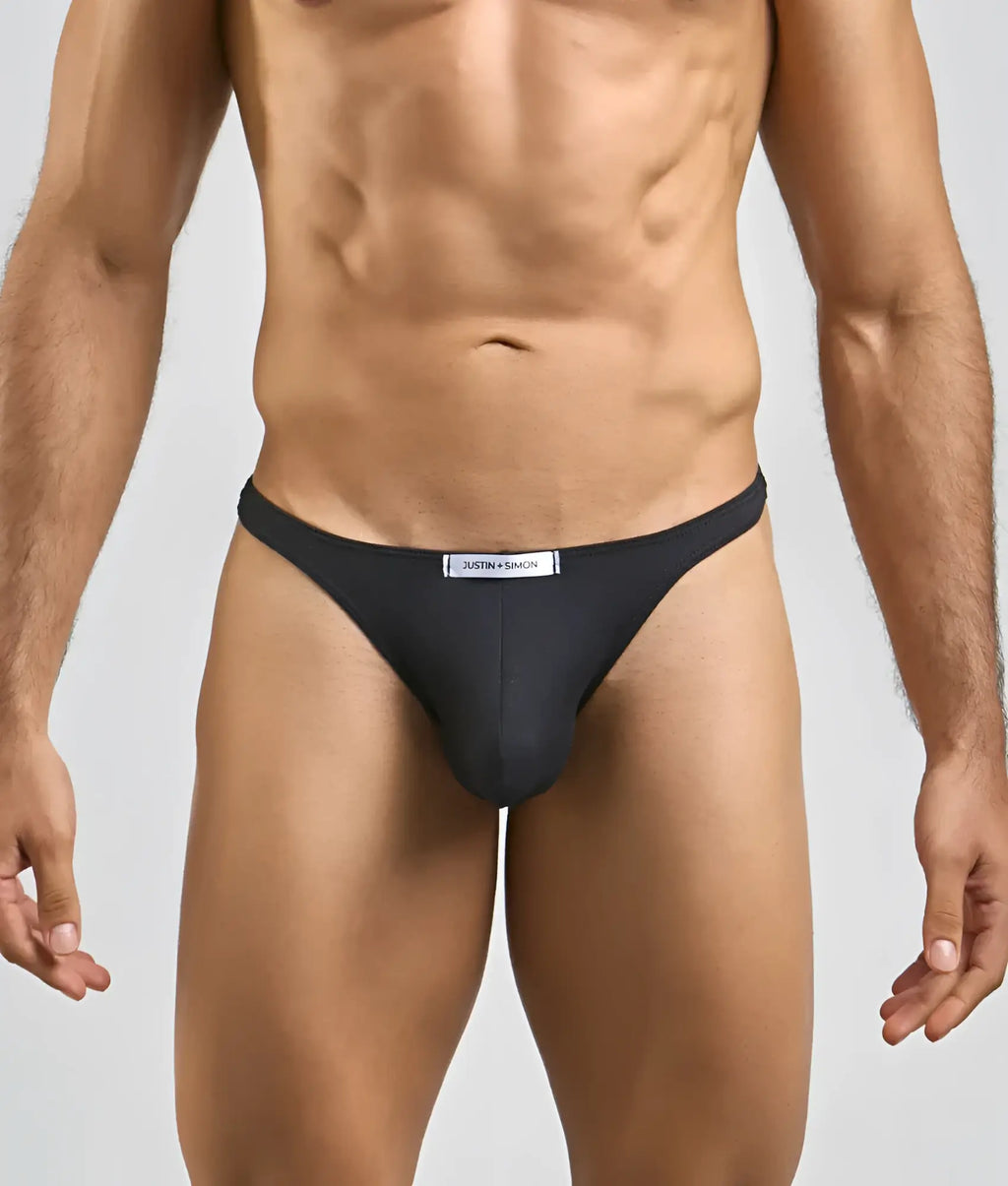 Black justin + simon men’s sexy peacheskin tanga briefs with sleek form-fitting design and white brand label waistband