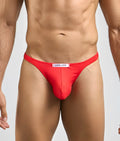 Red justin simon thong with white waistband label made of peachskin fabric for men’s sexy tanga underwear