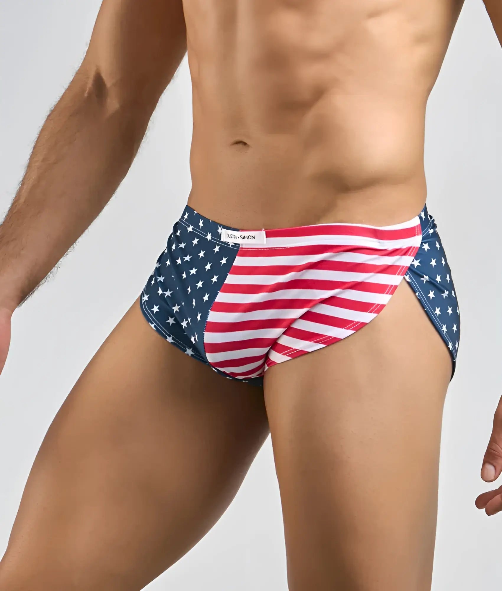 Justin + Simon running short men’s swim trunks in red white and blue with an American flag star spangled design