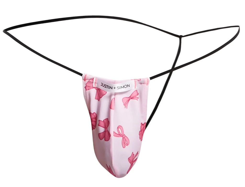 Pink bow-patterned thong g-string by justin + simon with black elastic straps in classic coquette style