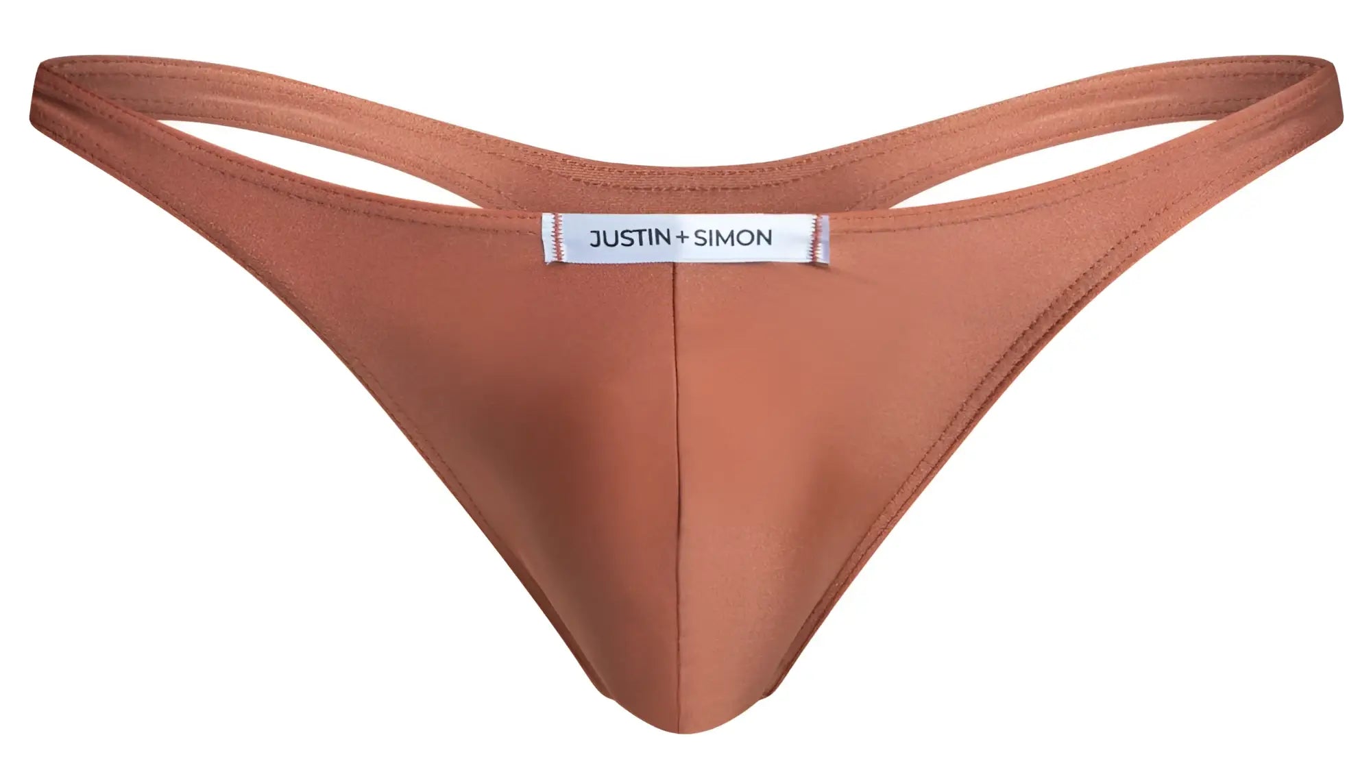 A sleek rust-colored ogre thong made of smooth fabric with minimalist design and justin simon label at center