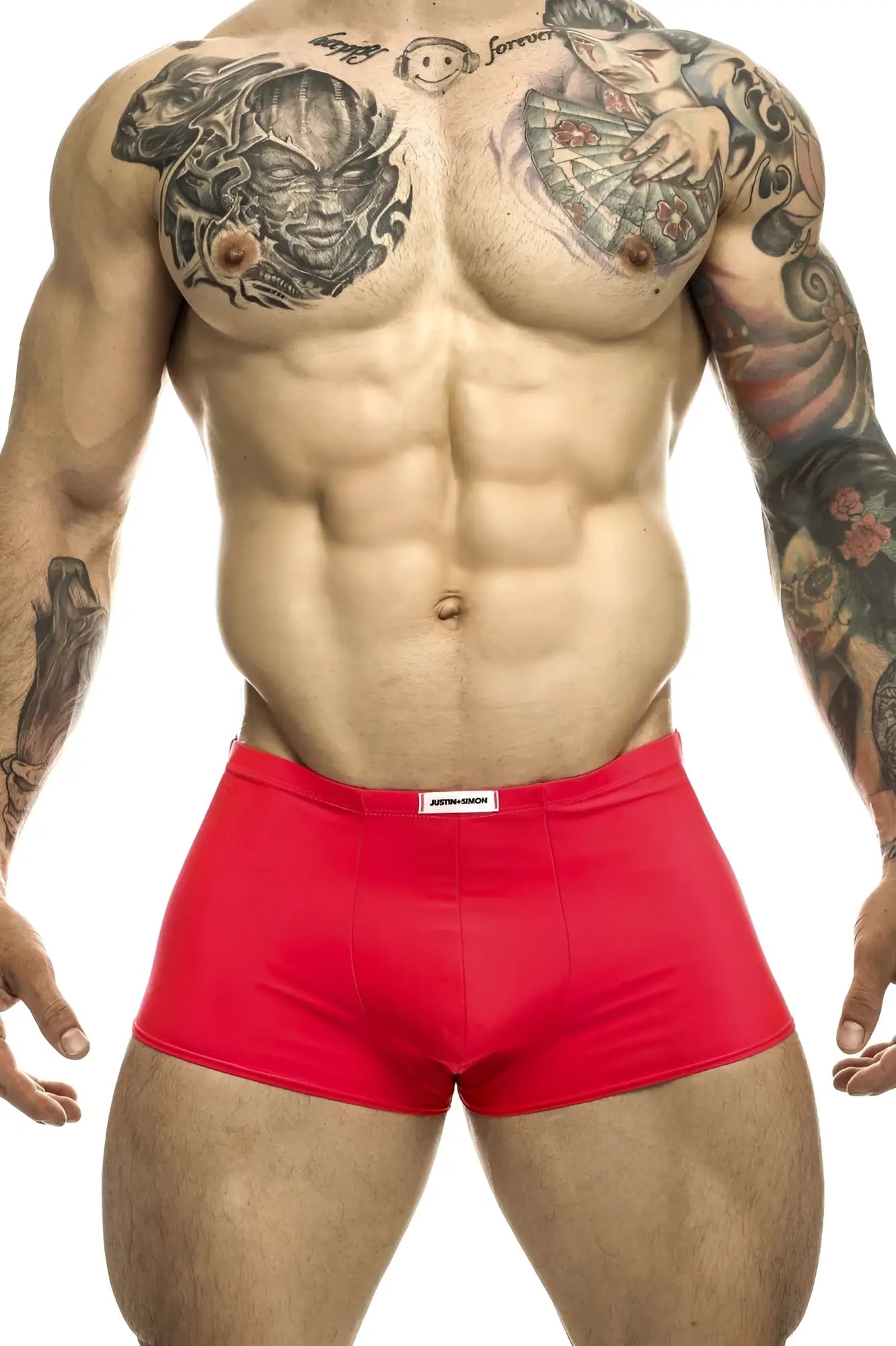 Red athletic briefs coral color with white brand tag at waistband by justin simon xsj08 classic trunks