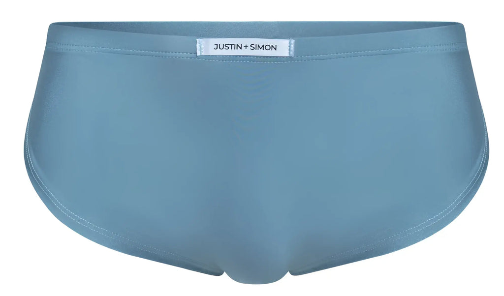 Light blue justin simon briefs with smooth seamless fabric finish shown with xsj09 metal green running shorts