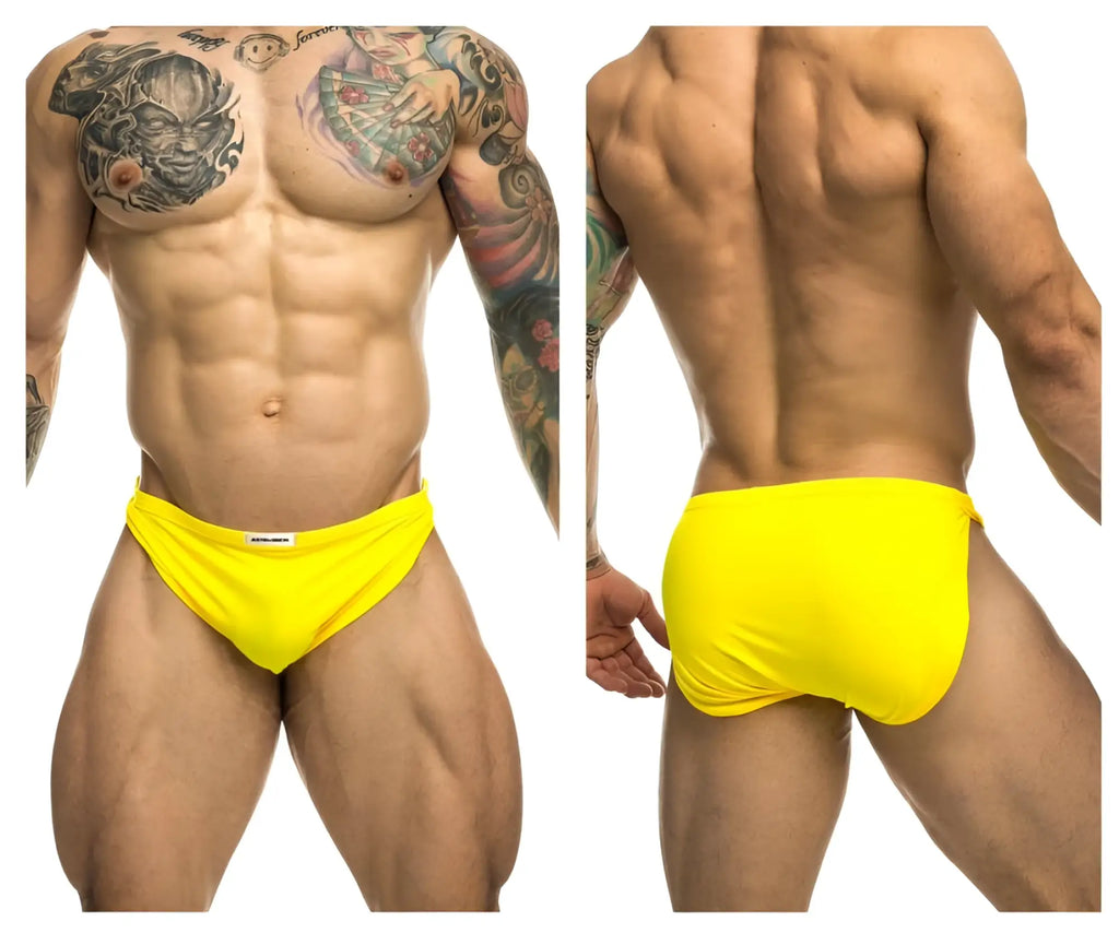 Bright yellow justin simon xsj09 running shorts with snug fit and white brand tag at the waistband
