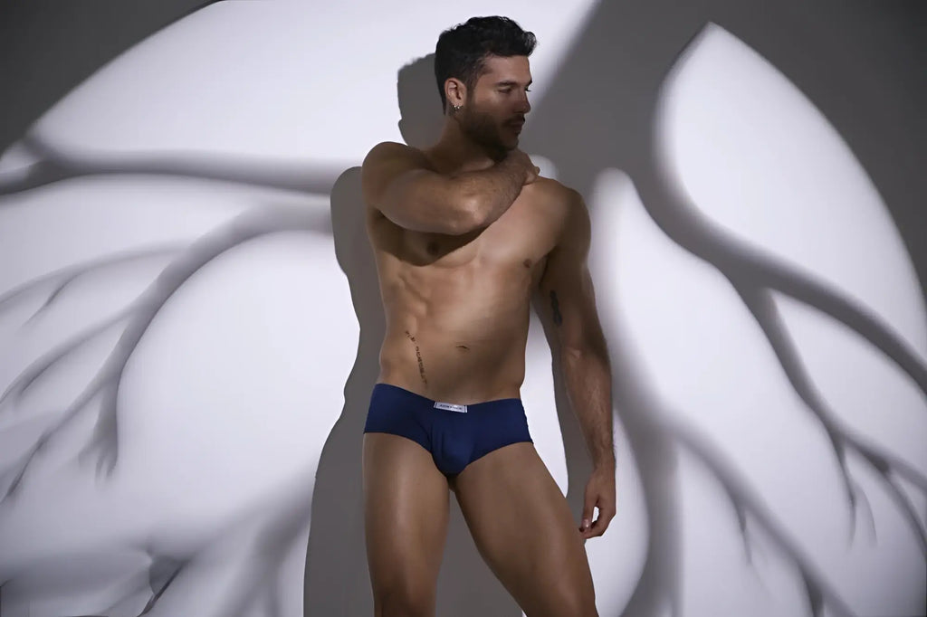 Navy blue cheeky bulge boxer briefs with white logo waistband from JUSTIN SIMON XSJ13 in peach navy color