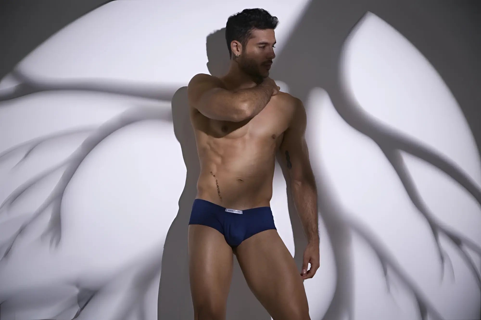 Navy blue cheeky bulge boxer briefs with white logo waistband from JUSTIN SIMON XSJ13 in peach navy color