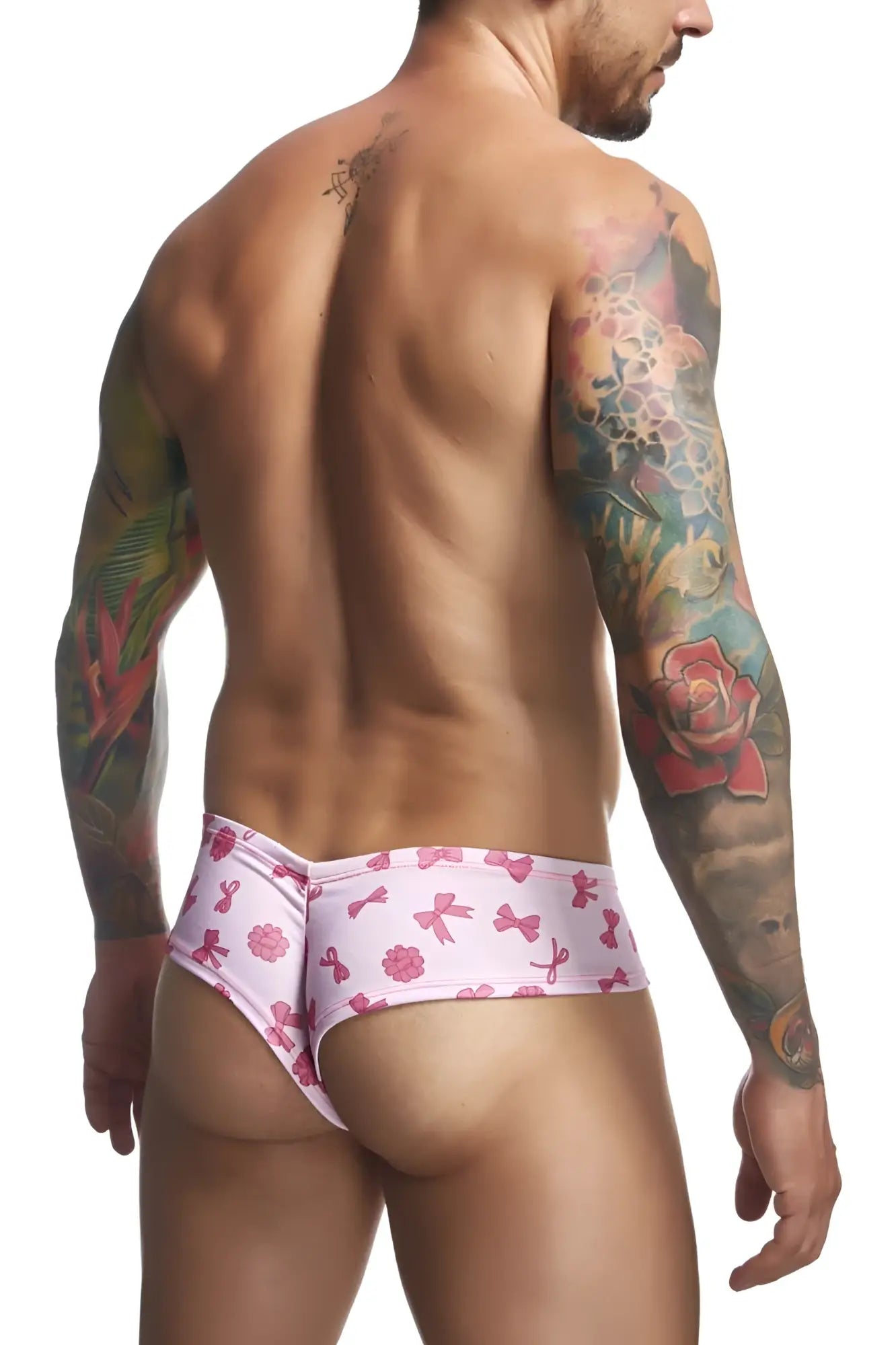 Justin+Simon XSJ22 cheek briefs in pink patterned swim trunks with playful bows and flowers design