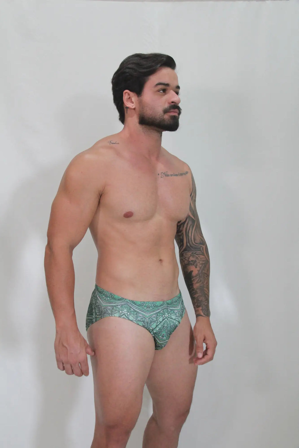 Green patterned kaleidoscope swim brief with intricate geometric designs perfect for beach and pool use