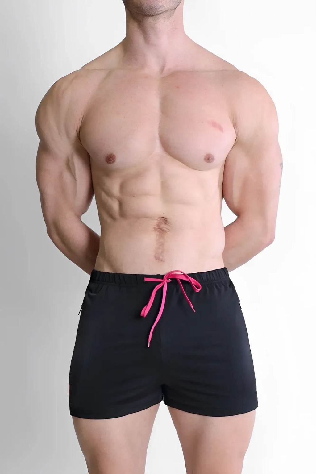 Karma 2 inch short shorts in black with vibrant pink drawstring and zipper pockets for athletic use
