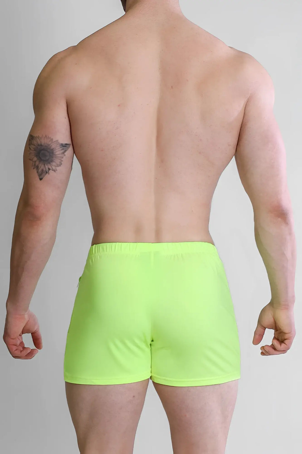 Neon green karma 2 inch athletic short shorts with zipper pockets designed for running and active wear