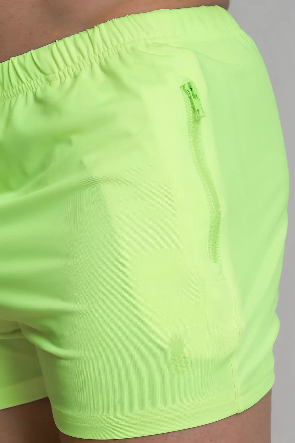 Karma 2 inch neon yellow athletic shorts with elastic waistband and zippered side pockets for active use