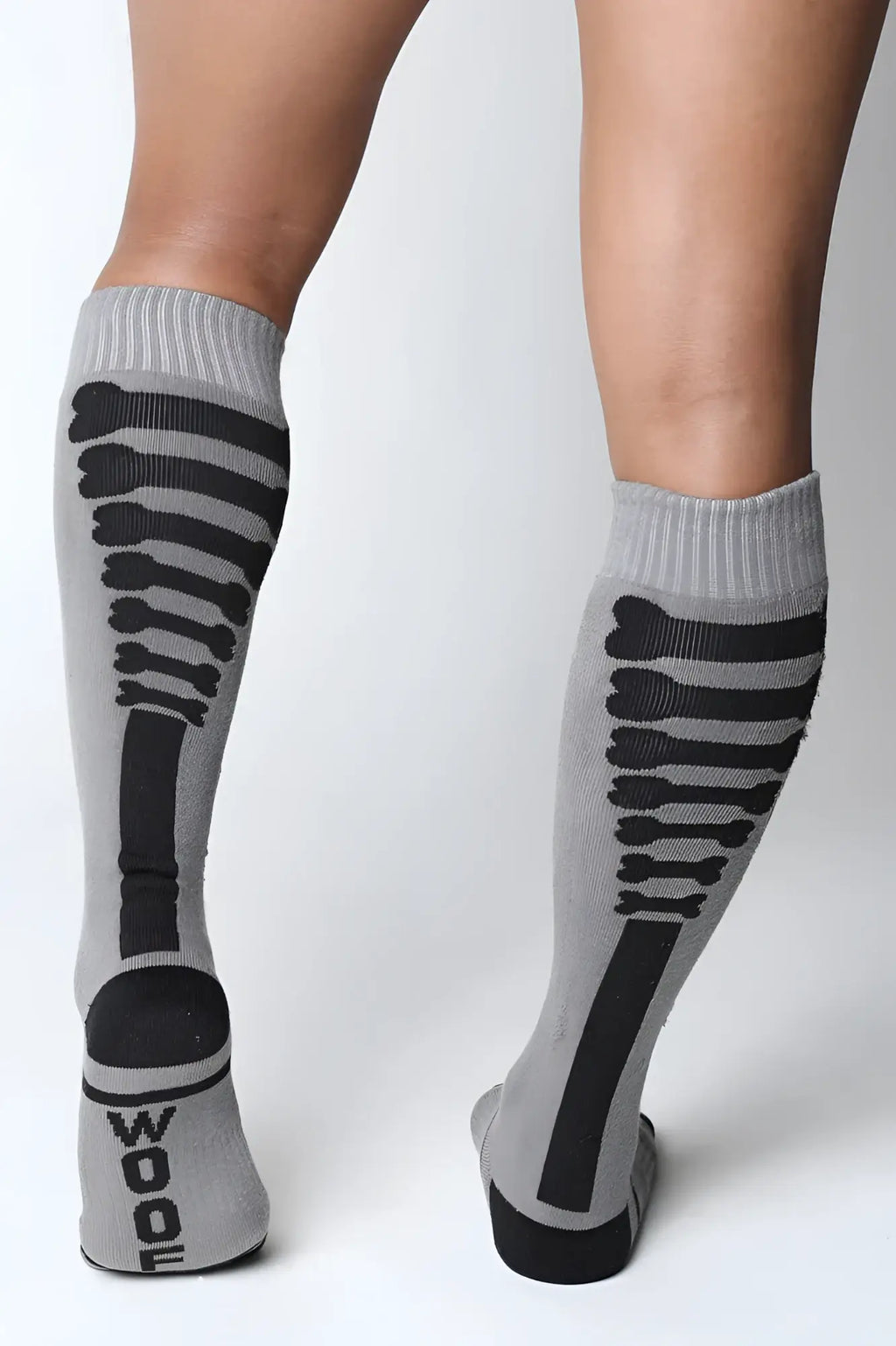 Gray knee high socks with black skeletal design and wood printed on heel from kennel club bones collection