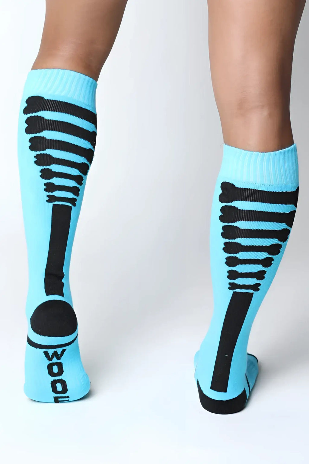 Light blue kennel club bones knee high sock with black skeletal ribcage design and wool printed on the heel