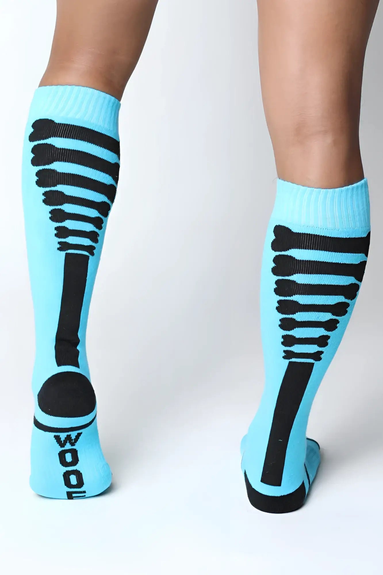 Light blue kennel club bones knee high sock with black skeletal ribcage design and wool printed on the heel