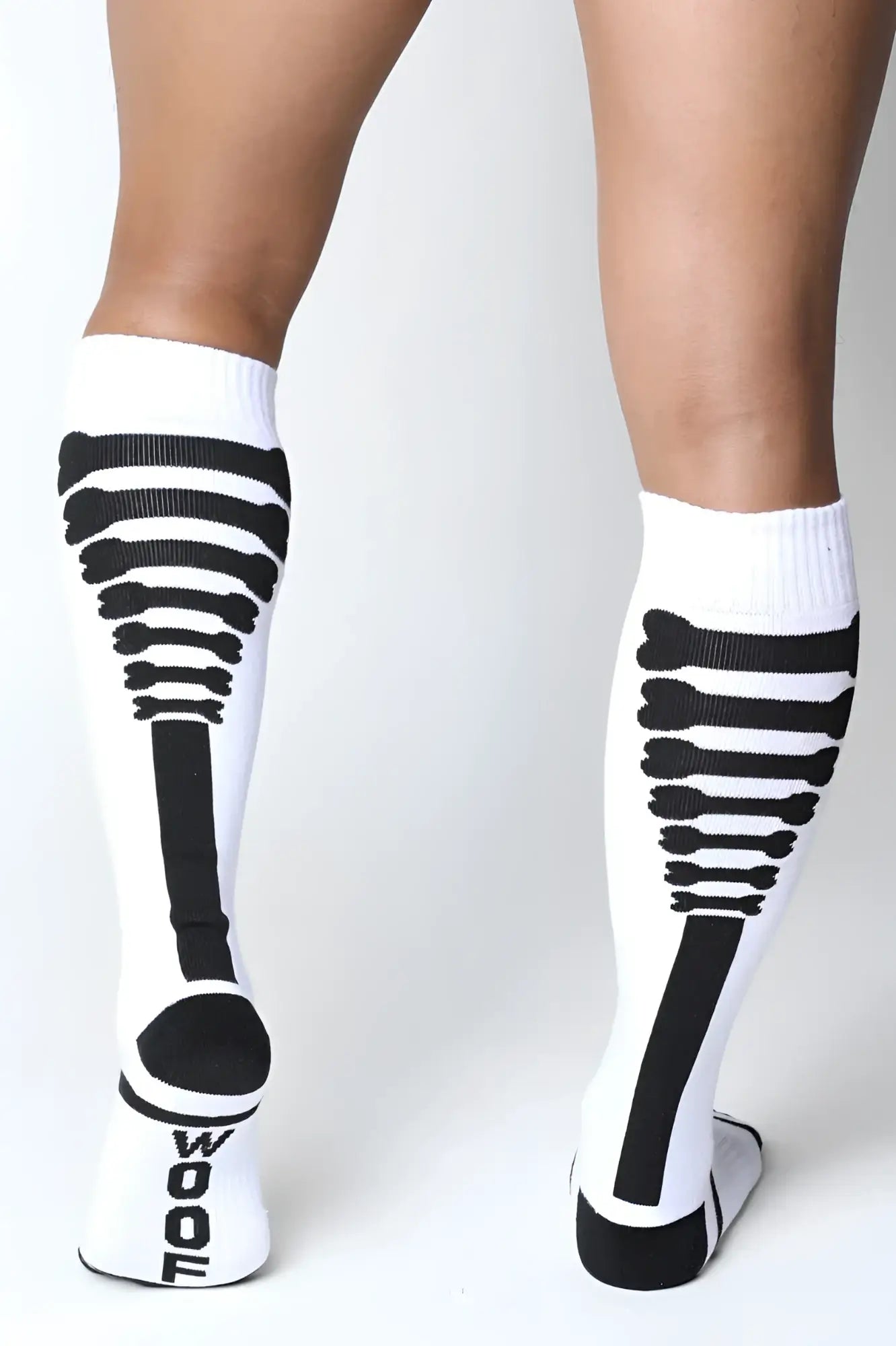 White knee high wool socks with black skeletal design and wool branding on the heel from Kennel Club Bones collection