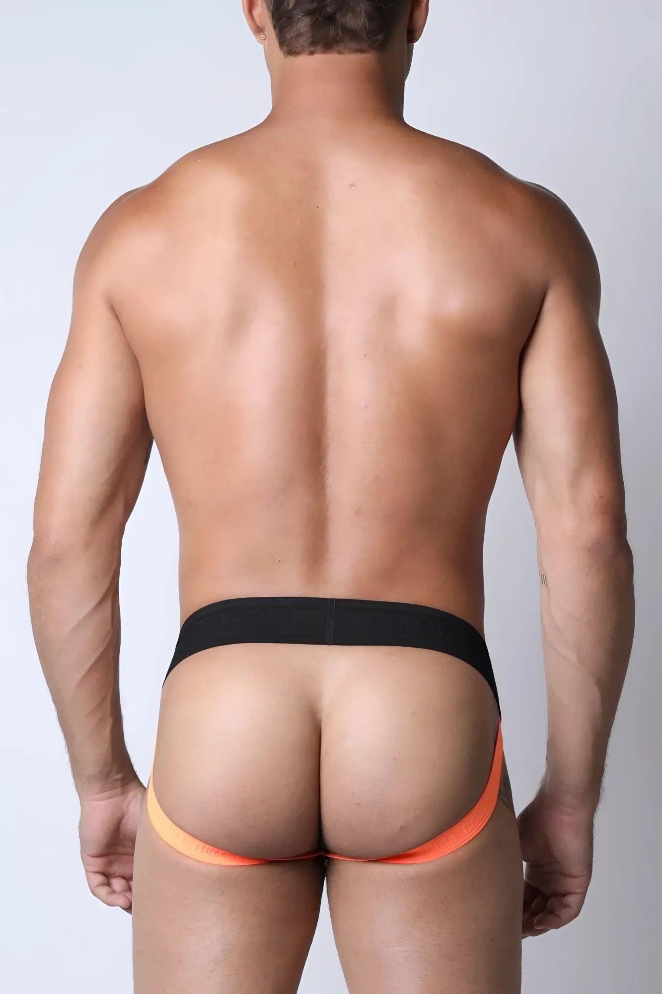 Black and orange kennel club lightning jockstrap with snug form-fitting design for athletic support