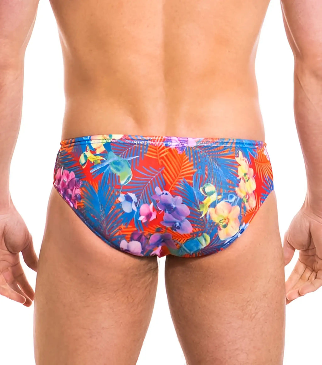 Vibrant tropical floral patterned kiniki continental tan through deep waist bikini swim trunks in red blue and purple hues